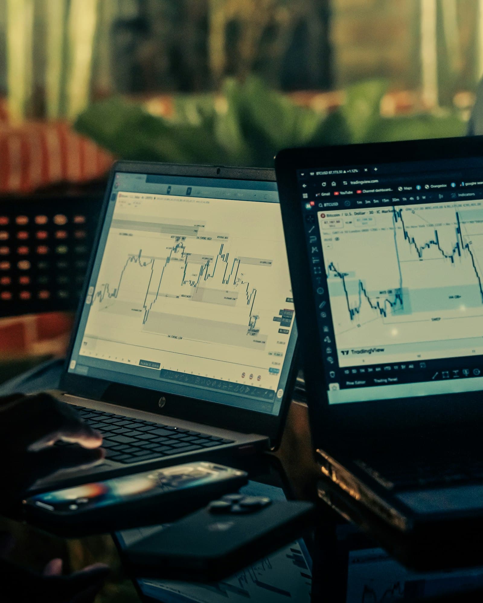Trader analysing live price charts across several monitors